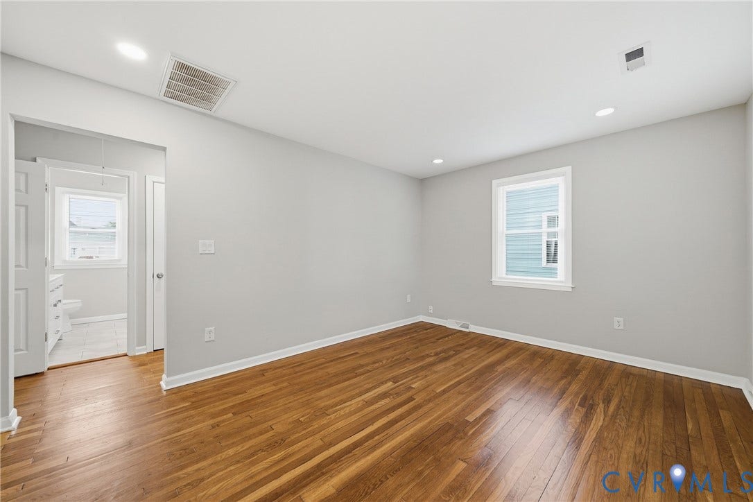 1718 Rogers, Richmond, VA 23223 Hardwood flooring, recessed ceiling lighting, window with white trim, light gray painted walls, and white paneled doors