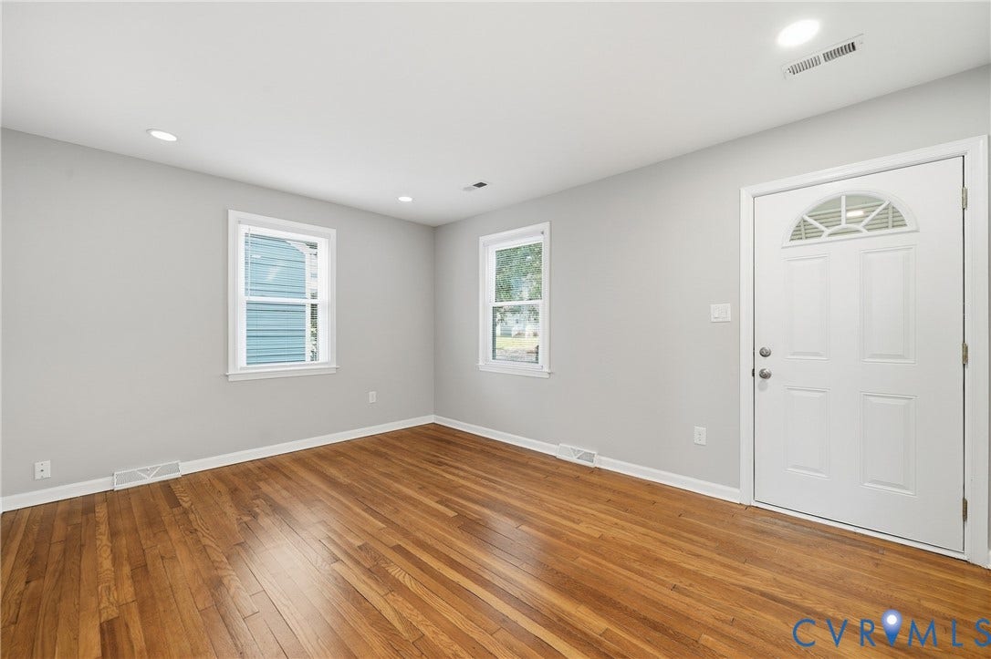1718 Rogers, Richmond, VA 23223 Wood-finish flooring, recessed lighting, and a paneled entry door with an arched transom window