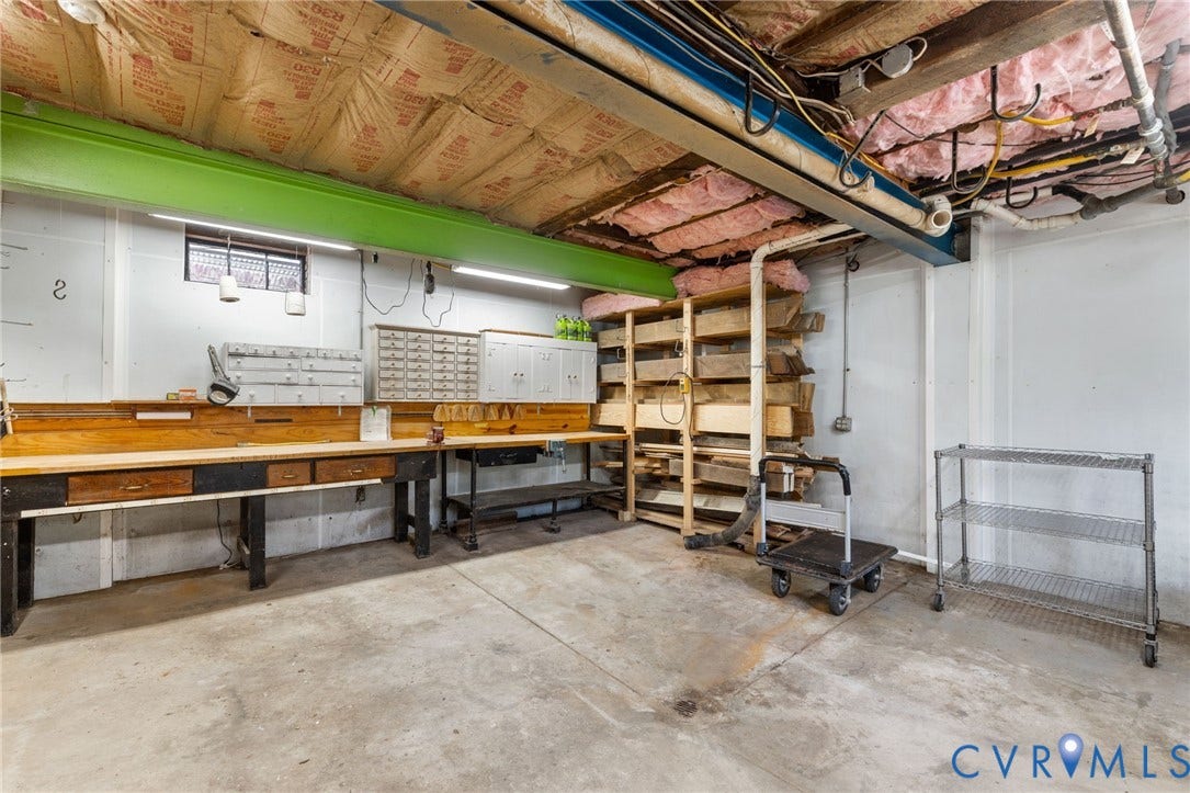 Extensive workbench area with integrated drawer storage and overhead cabinets