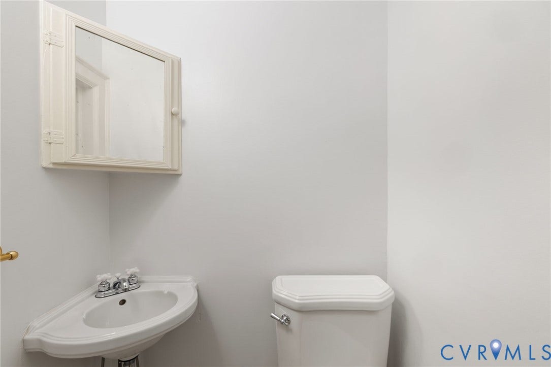 Corner pedestal sink with chrome faucet