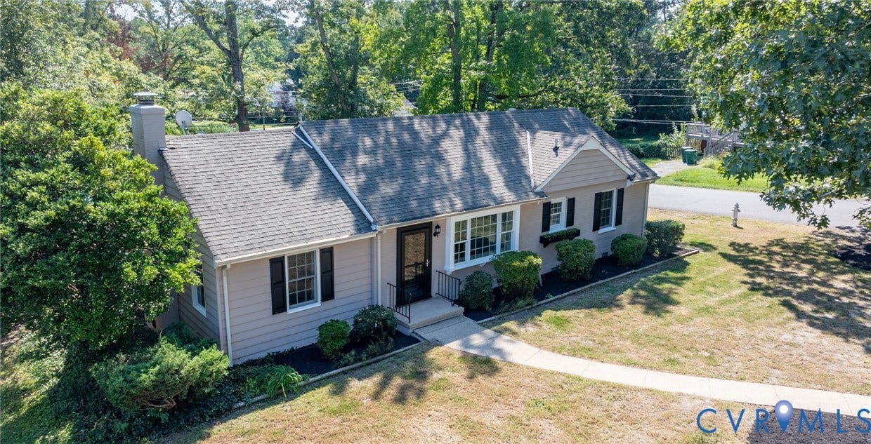 8415 Holly Hill Road, Henrico, VA 23229 Light-toned exterior with dark shutters, gabled roof, and a prominent chimney