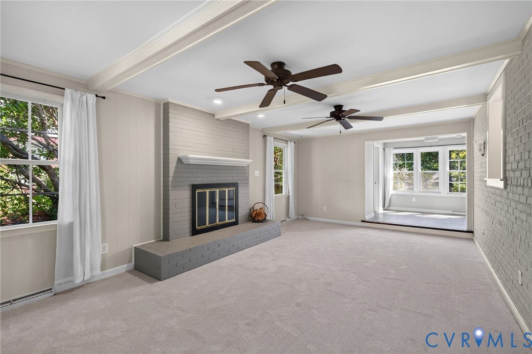 8415 Holly Hill Road, Henrico, VA 23229 Recessed lighting, exposed ceiling beams, and a brick fireplace with a hearth