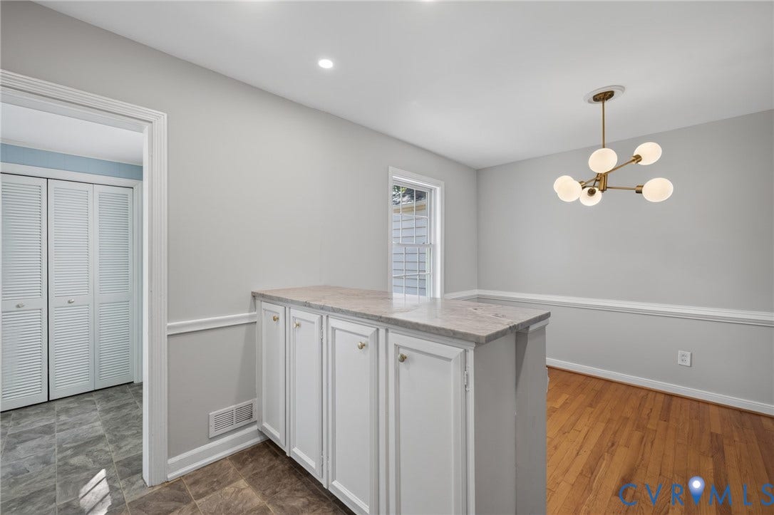 8415 Holly Hill Road, Henrico, VA 23229 Built-in cabinetry with a stone-finish countertop, wood-finish flooring, recessed lighting, and a modern chandelier