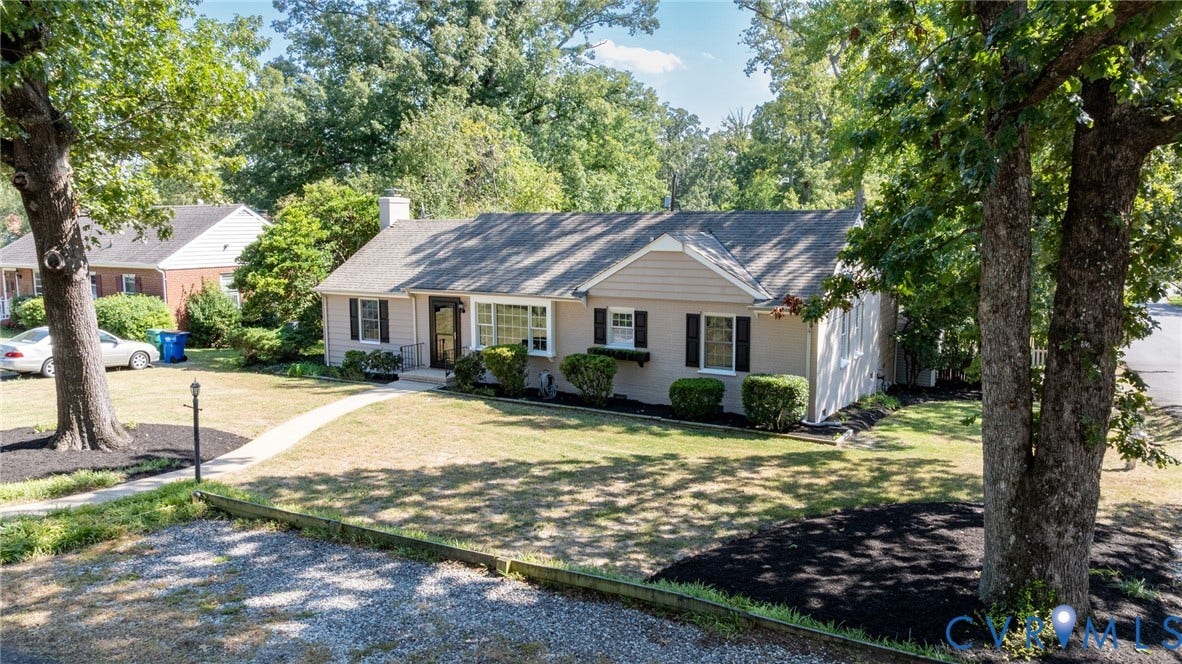 8415 Holly Hill Road, Henrico, VA 23229 Single-story exterior with a gabled roofline, front lawn, mature trees, and a curved sidewalk
