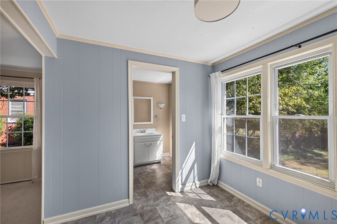 8415 Holly Hill Road, Henrico, VA 23229 Light blue paneled walls, white trim, and a patterned flooring