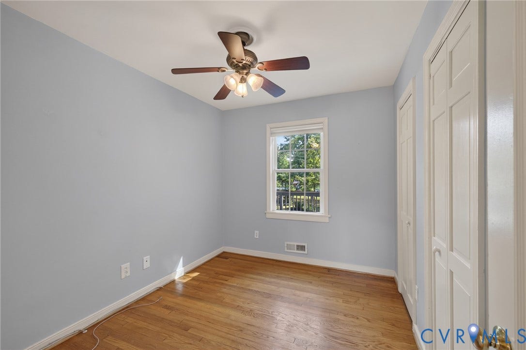 8415 Holly Hill Road, Henrico, VA 23229 Hardwood flooring, painted walls, single window, louvered closet doors, and a ceiling fan with integrated lighting