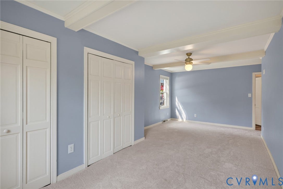 8415 Holly Hill Road, Henrico, VA 23229 Beamed ceiling with an integrated ceiling fan, light-toned carpeting, and a window with natural light
