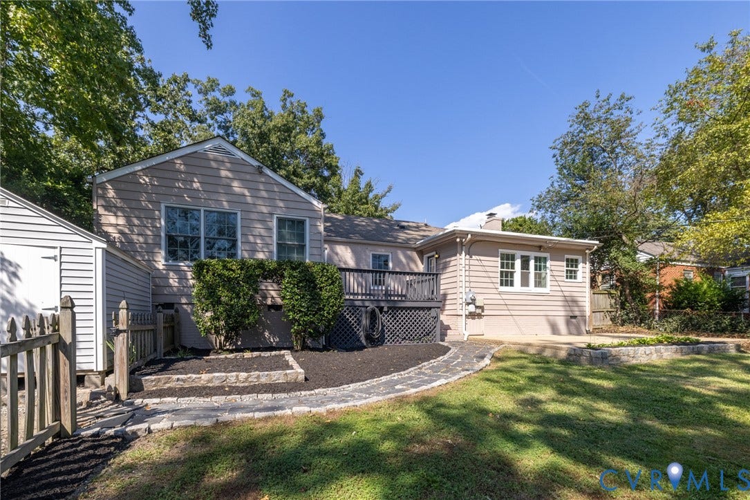 8415 Holly Hill Road, Henrico, VA 23229 Exterior siding with multiple windows, elevated rear deck, paved walkway, and a detached storage shed