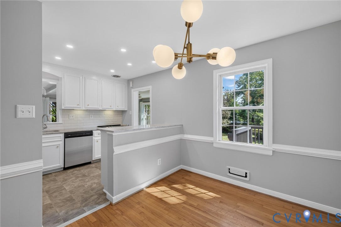 8415 Holly Hill Road, Henrico, VA 23229 Hardwood flooring, modern chandelier, double-hung window, crown molding, and stainless steel dishwasher