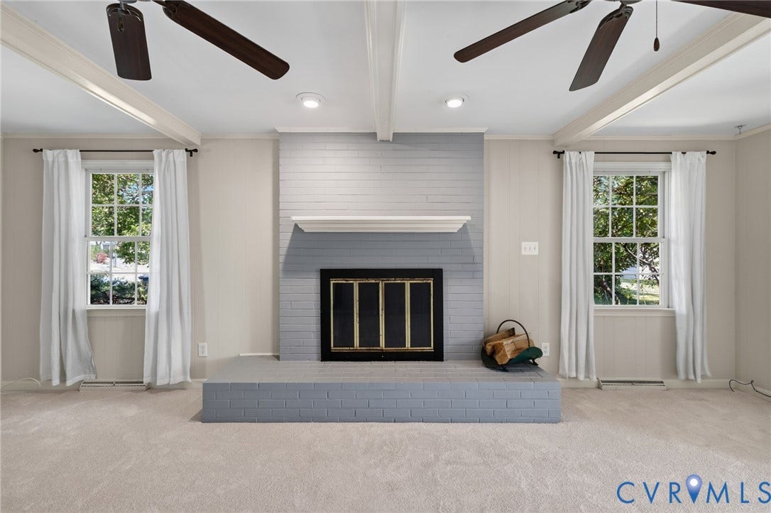 8415 Holly Hill Road, Henrico, VA 23229 Recessed lighting illuminates a painted brick fireplace with a mantel