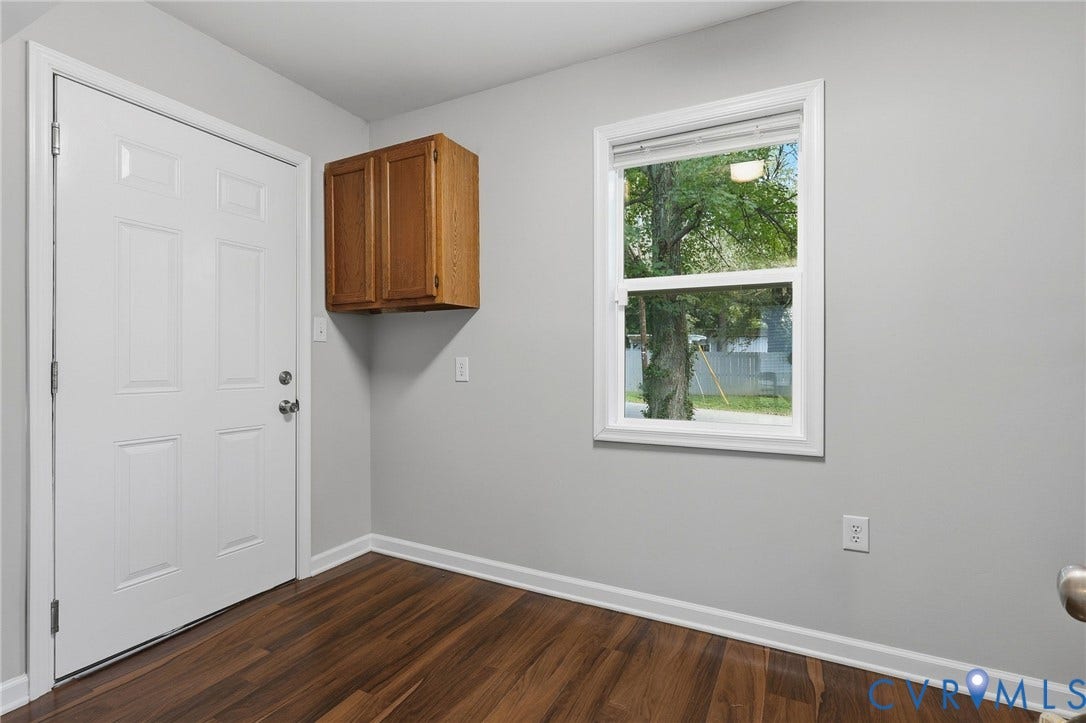 Wood-finish flooring, light grey wall paint, and white trim