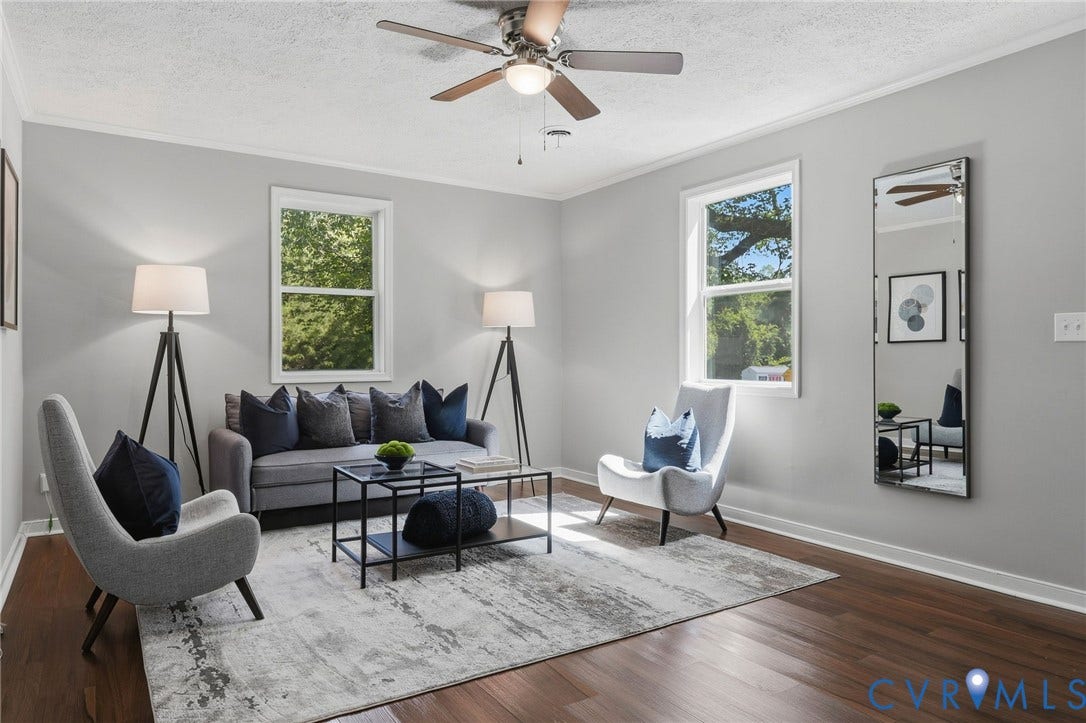 Wood-finish flooring, white trim, and a ceiling fan with integrated lighting
