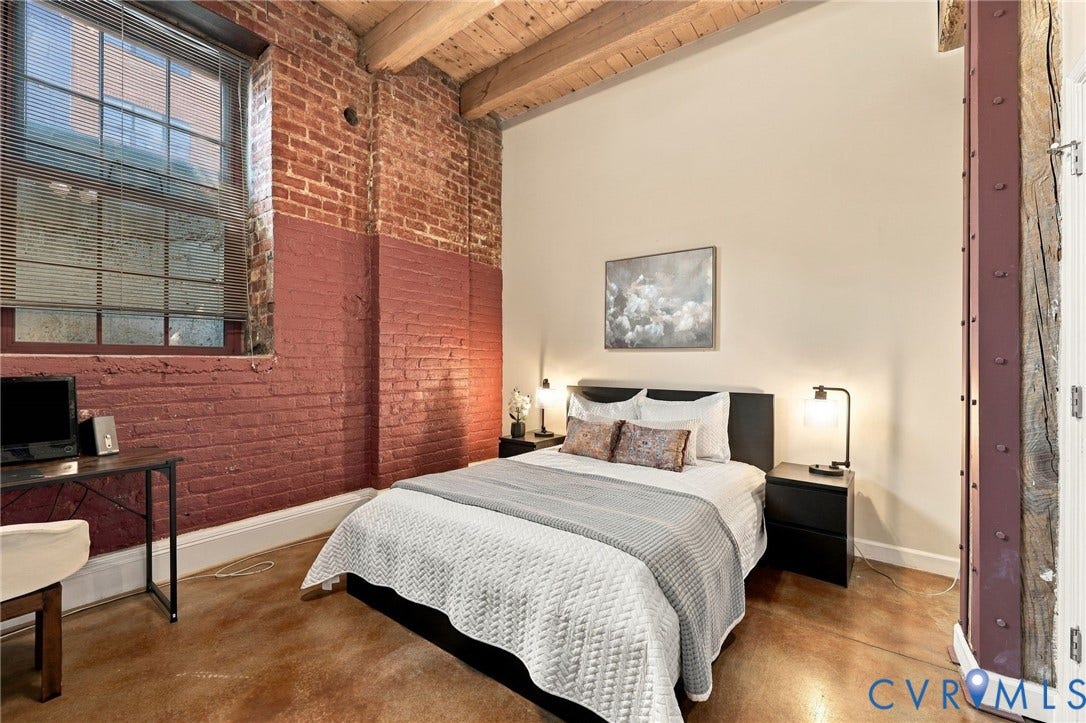 815 Porter Street, #U106, Manchester, Richmond, VA 23224 High timber ceilings extend into the primary bedroom with a large window.