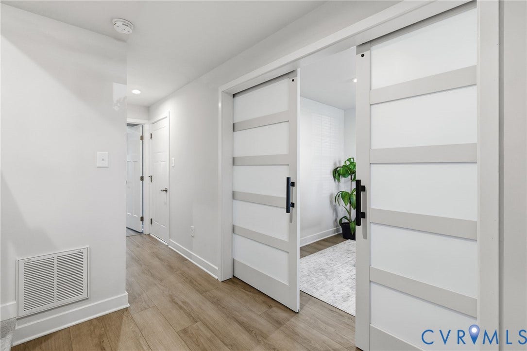 Wood-finish LV wood finished flooring throughout the first floor, recessed lighting, and white paneled interior doors