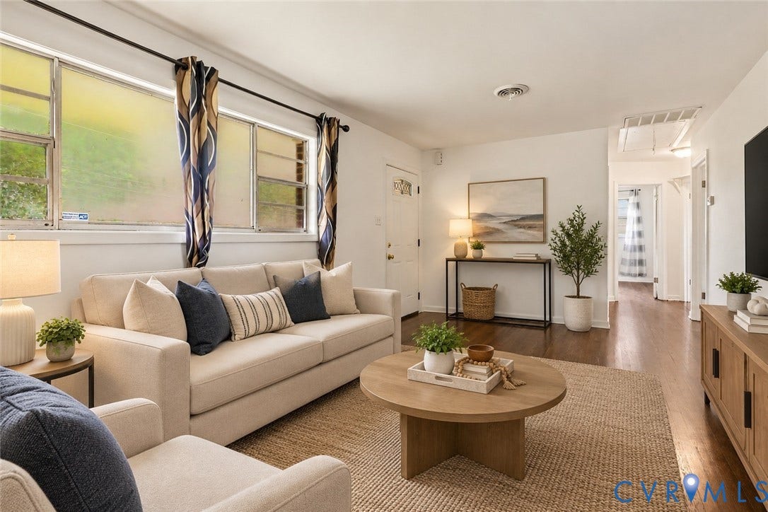 Hardwood flooring, white painted walls, and multiple windows