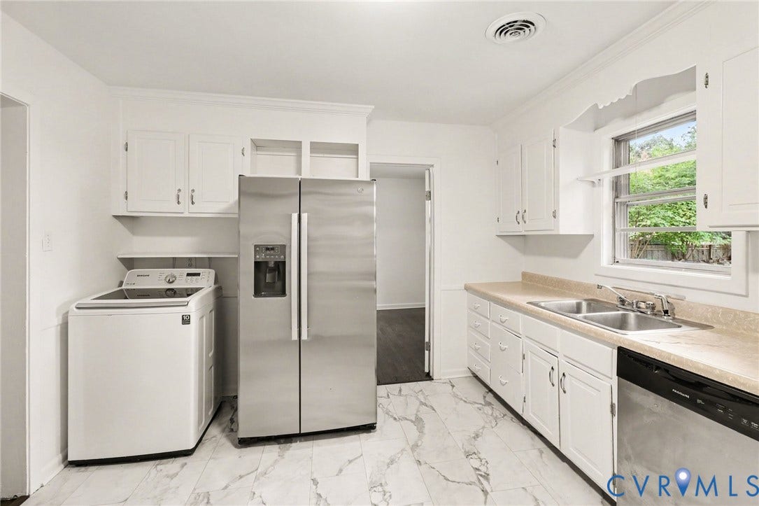 Kitchen featuring white cabinetry, stainless steel appliances, dual basin sink, and wood-finish flooring