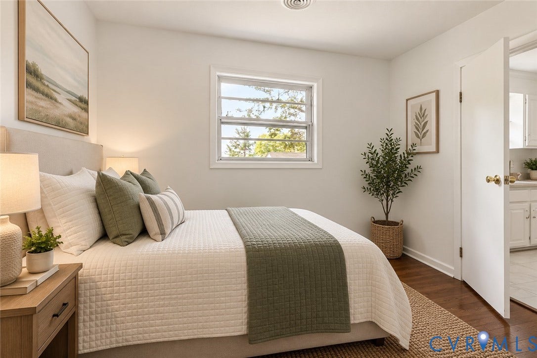 Hardwood-finish flooring, white walls, double-hung window, and a paneled interior door