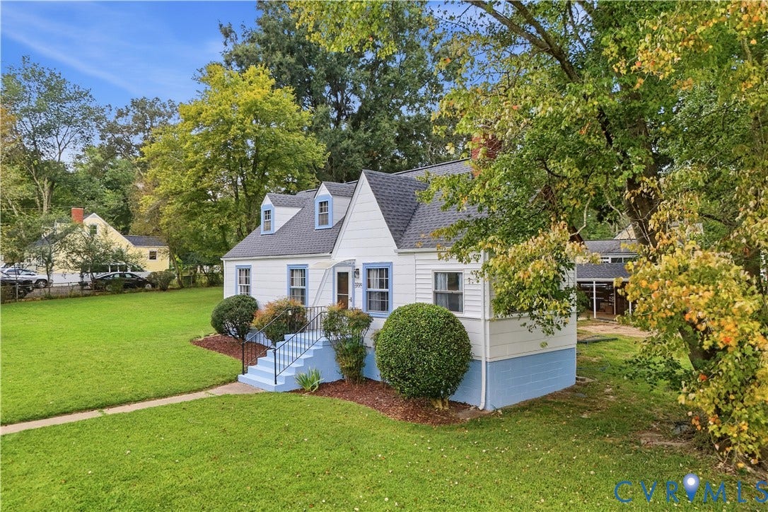 White siding exterior with blue trim accents