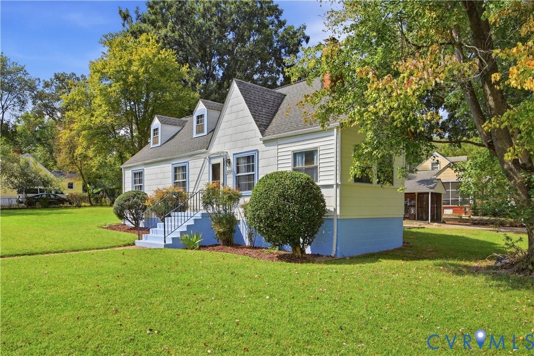 Two-story residence featuring dormer windows, exterior siding, and a gabled roofline