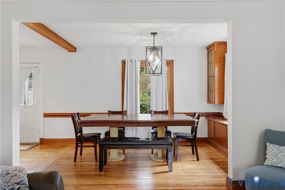 Hardwood flooring, wood trim accents, a built-in corner cabinet with glass-front doors, a built-in bench, and a modern geometric pendant light fixture