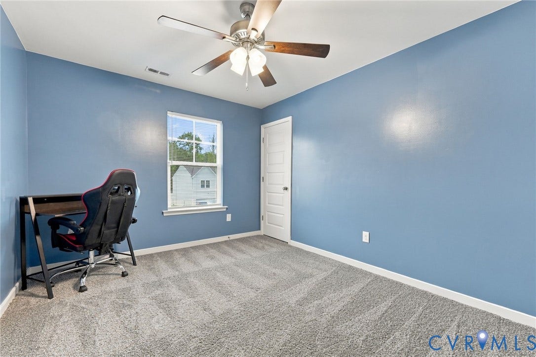 Generously sized bedroom 3 with natural light, ceiling fan, and ample closet space.