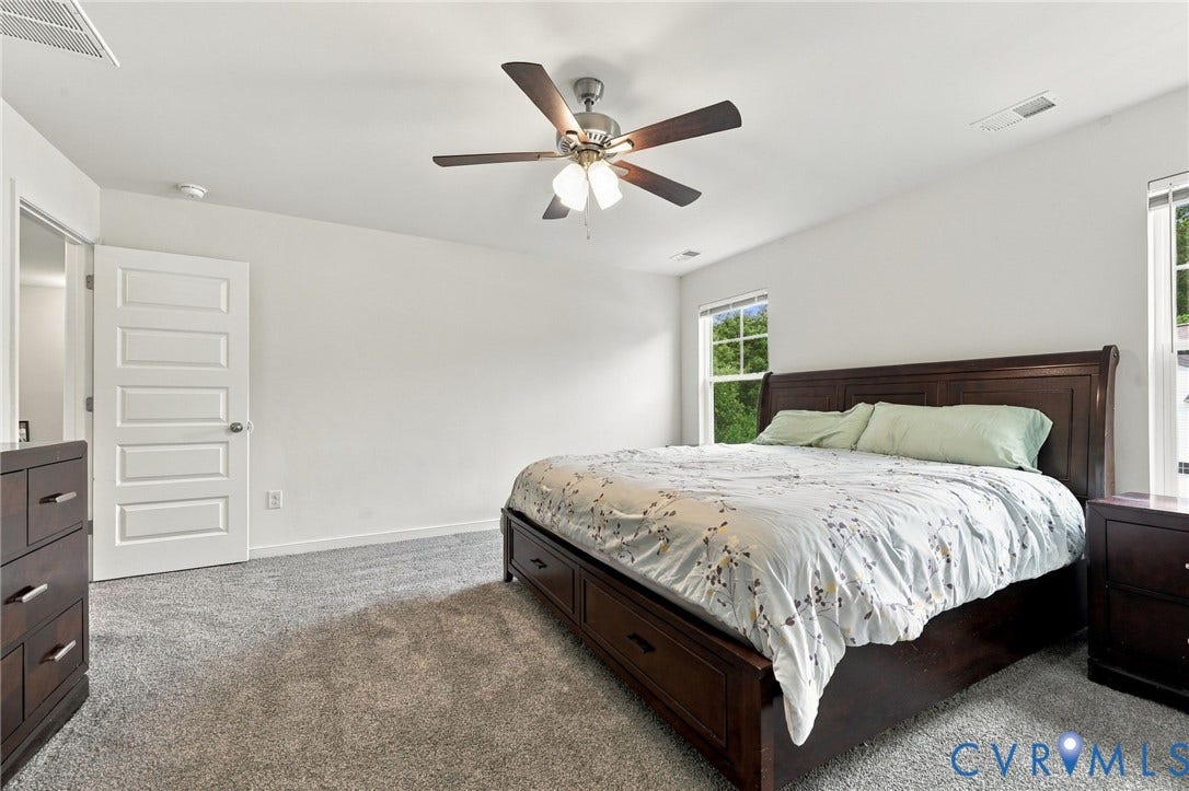 Bright primary retreat with neutral finishes, plush carpeting, and great natural light.