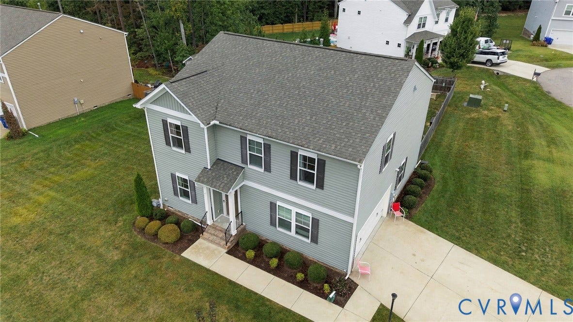 Aerial view highlighting homes manicured landscaping and attractive exterior.