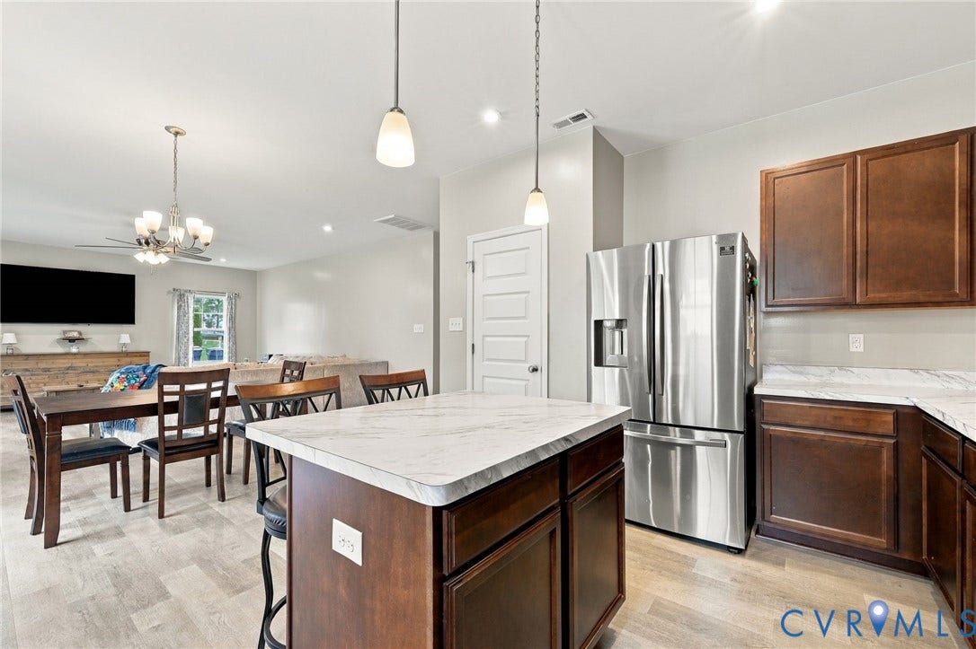 Large center island provides additional prep space and casual seating.