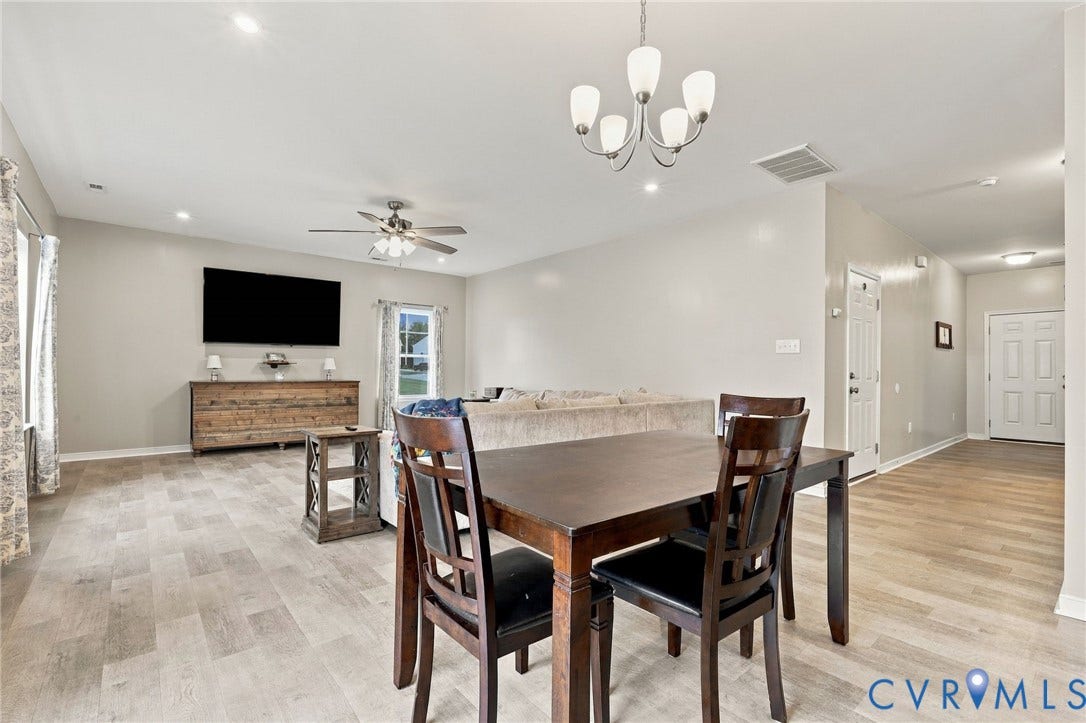 The kitchen and dining area flow seamlessly into the spacious family room, creating an open layout ideal for everyday living and entertaining.