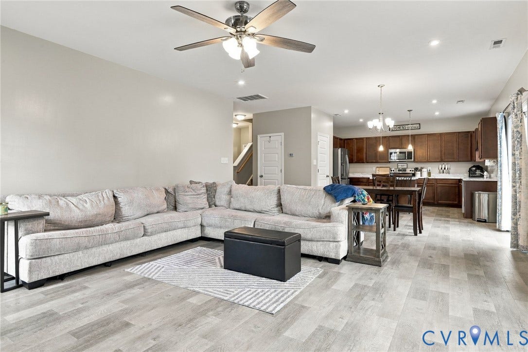 Expansive main-level living space seamlessly connects the family room, dining area, and kitchen for a comfortable open-concept layout.