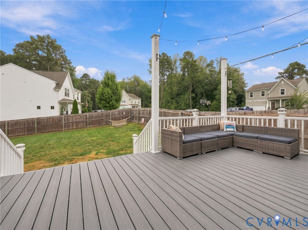 Another view of the large composite deck with direct access from the home and multiple areas for seating and dining.