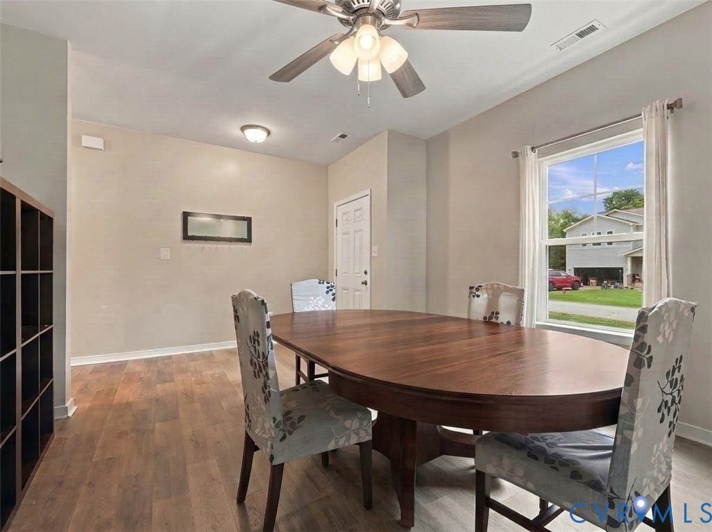 Large front-facing window fills the dining space with natural light, creating a bright and inviting atmosphere.