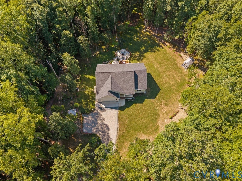 5927 Trenholm Village Drive, Trenholm Village, Powhatan, VA 23139 Wooded property featuring a multi-level residence, attached garage, and gravel driveway
