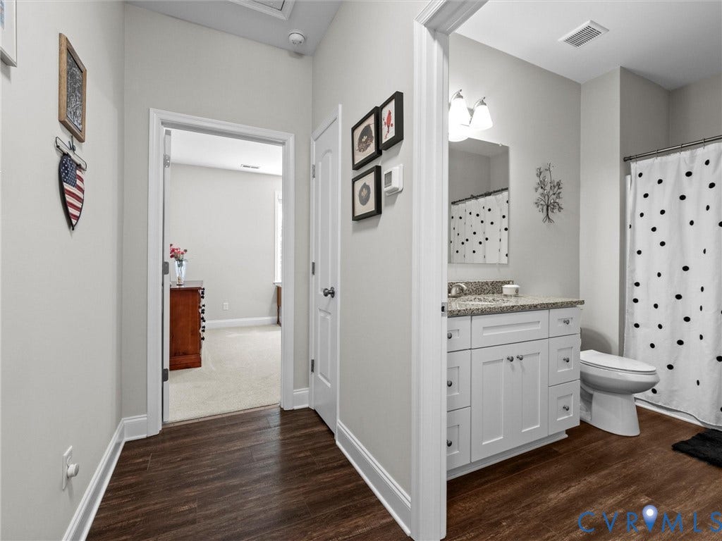 5927 Trenholm Village Drive, Trenholm Village, Powhatan, VA 23139 White vanity with granite countertop, wood-finish flooring, and a shower with a curtain rod