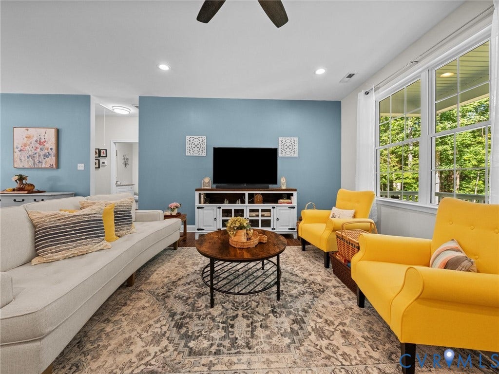 5927 Trenholm Village Drive, Trenholm Village, Powhatan, VA 23139 Recessed lighting, ceiling fan, white trim windows, wood-finish media console, and light blue wall finishes