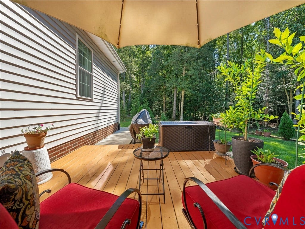 5927 Trenholm Village Drive, Trenholm Village, Powhatan, VA 23139 Deck with wood-finish flooring, white siding exterior, and a green lawn