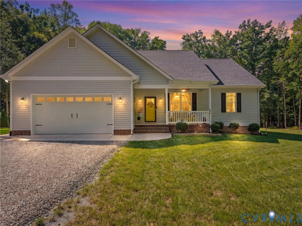 5927 Trenholm Village Drive, Trenholm Village, Powhatan, VA 23139 Siding exterior with brick accents, covered front porch, gravel driveway, and attached garage