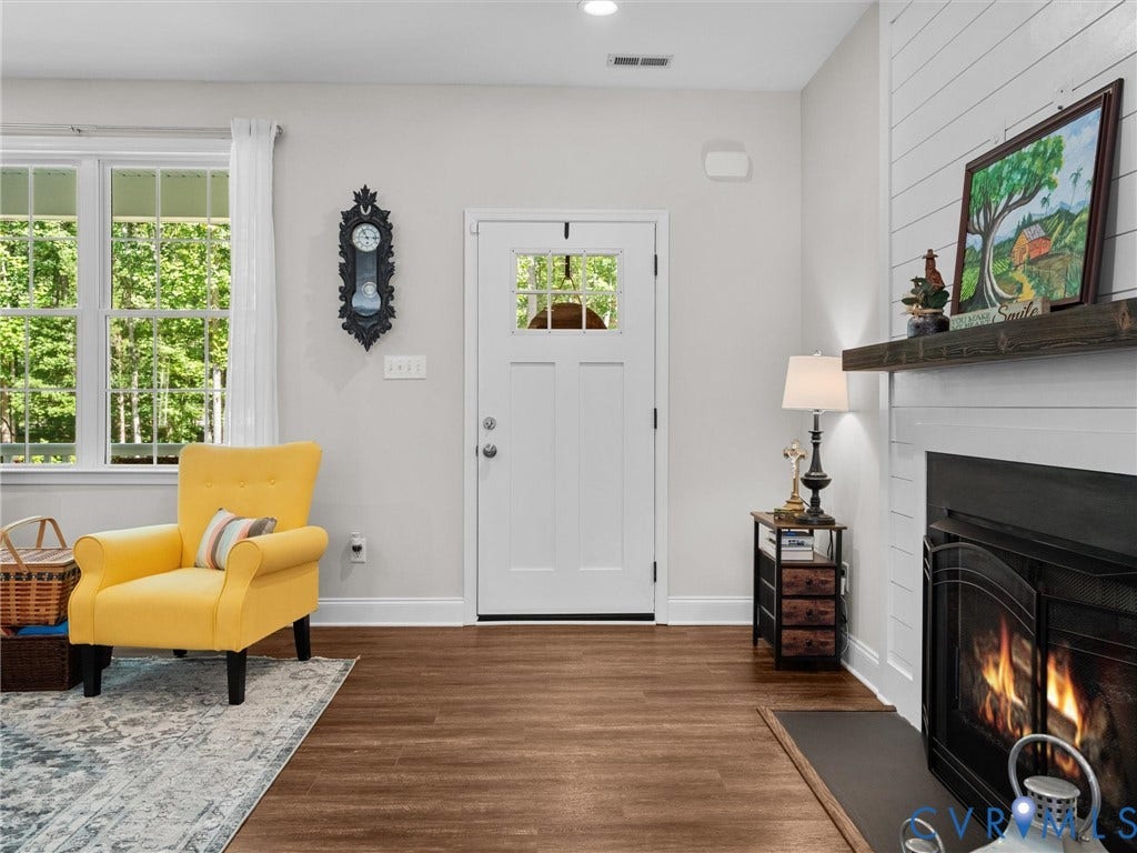 5927 Trenholm Village Drive, Trenholm Village, Powhatan, VA 23139 White entry door with a divided light window, wood-finish flooring, recessed lighting, and a fireplace with a wood mantel
