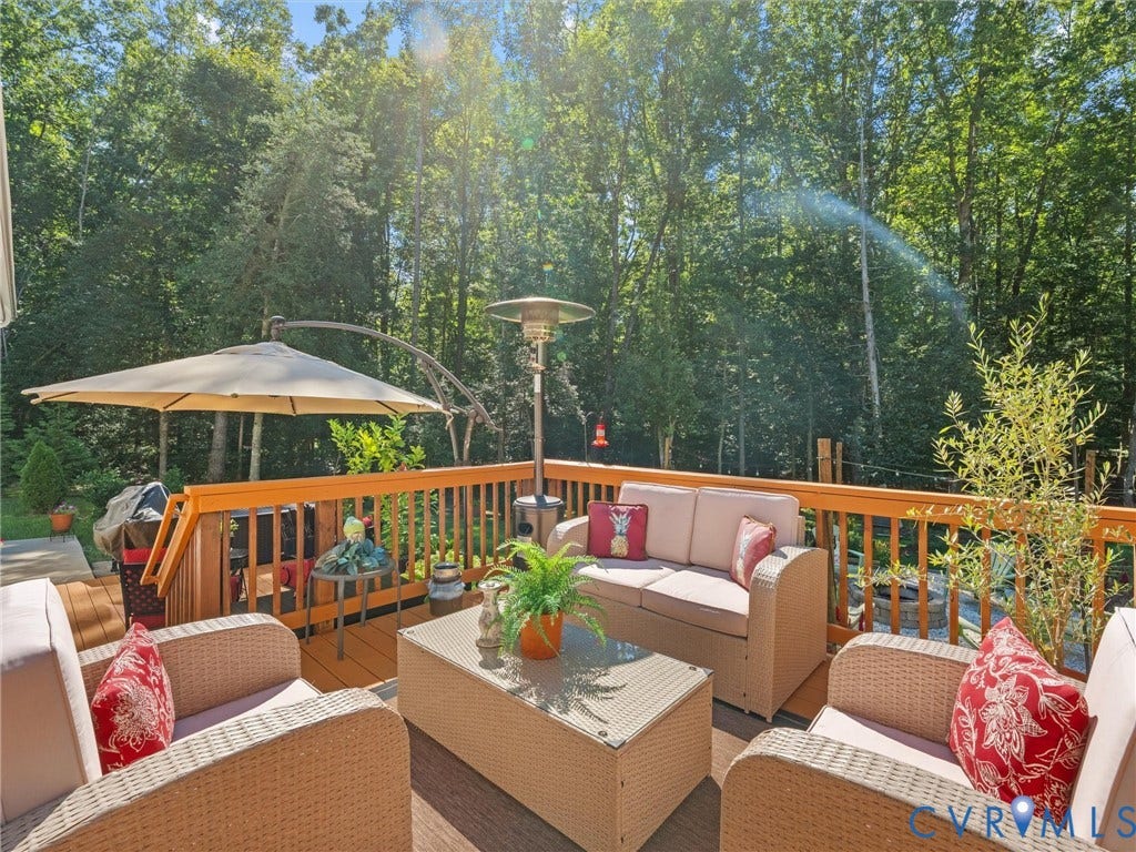 5927 Trenholm Village Drive, Trenholm Village, Powhatan, VA 23139 Expansive wood deck with a full-height wood railing, surrounded by mature trees