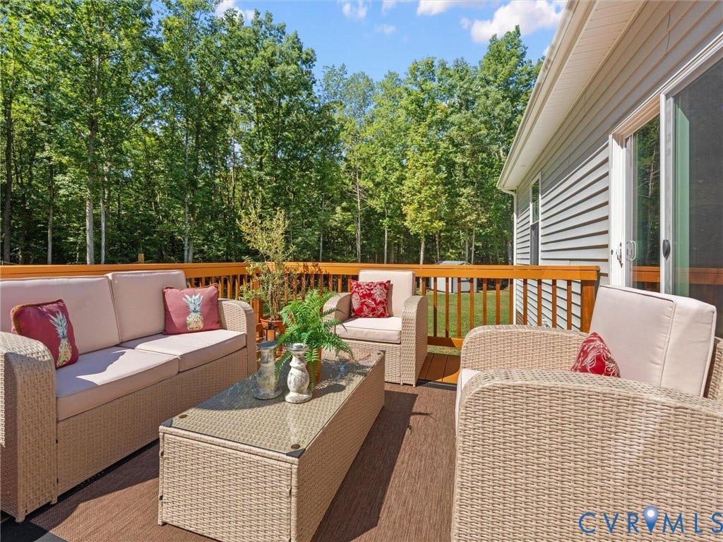 5927 Trenholm Village Drive, Trenholm Village, Powhatan, VA 23139 Spacious outdoor deck with a wood-tone composite surface, wood railing, and direct access to the interior via a sliding glass door