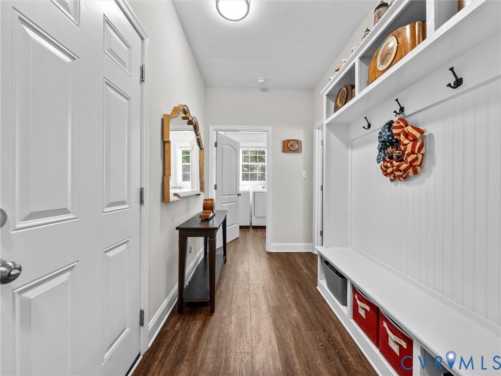 5927 Trenholm Village Drive, Trenholm Village, Powhatan, VA 23139 Entryway featuring white paneled doors, built-in mudroom seating with storage, upper shelving, and wood-finish flooring