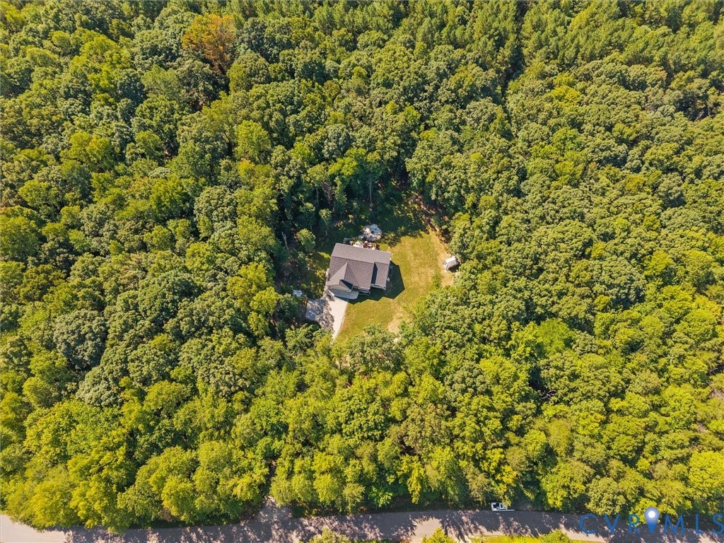 5927 Trenholm Village Drive, Trenholm Village, Powhatan, VA 23139 Expansive wooded surroundings with a residential structure, asphalt driveway, and green lawn