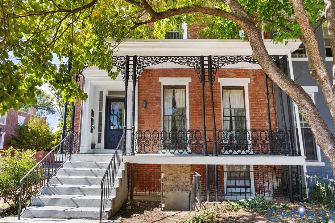 Front facade featuring original ornamental ironwork.