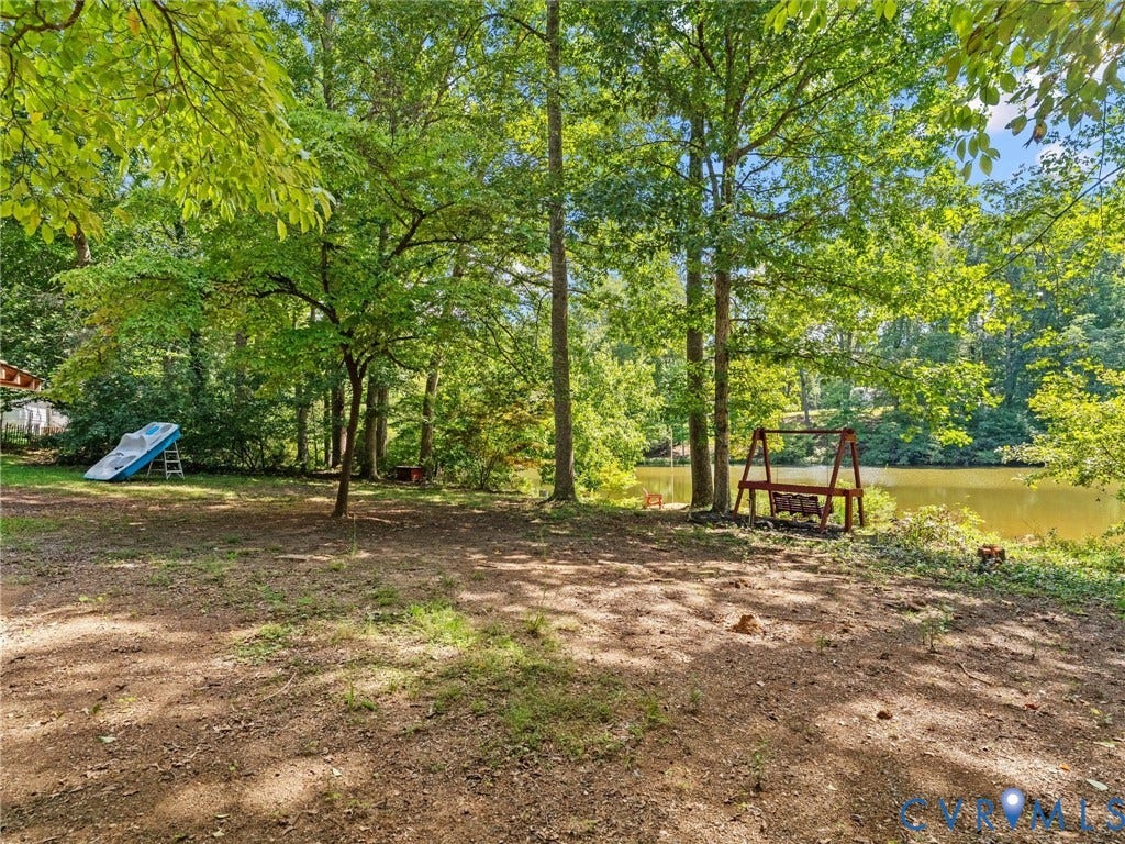 2135 Lakeview Drive, Lake Shawnee, Powhatan, VA 23139 Lake property featuring mature trees and a wooden swing set