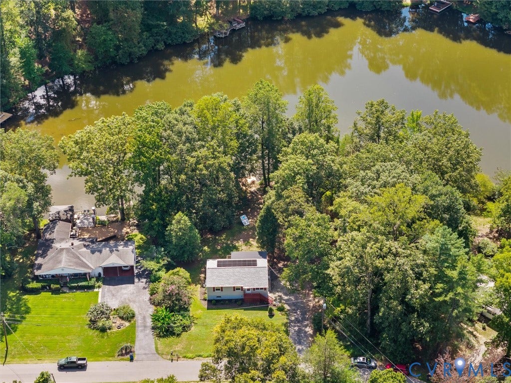 2135 Lakeview Drive, Lake Shawnee, Powhatan, VA 23139 Waterfront property featuring a private dock and mature trees