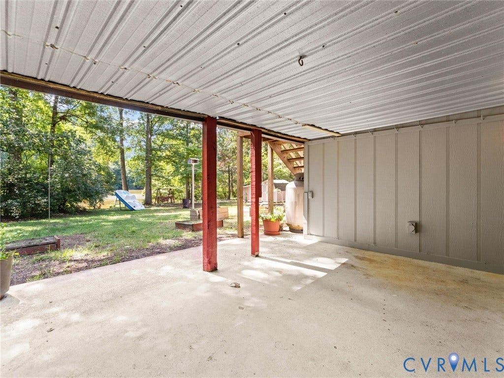 2135 Lakeview Drive, Lake Shawnee, Powhatan, VA 23139 Covered rear concrete patio with a corrugated metal roof