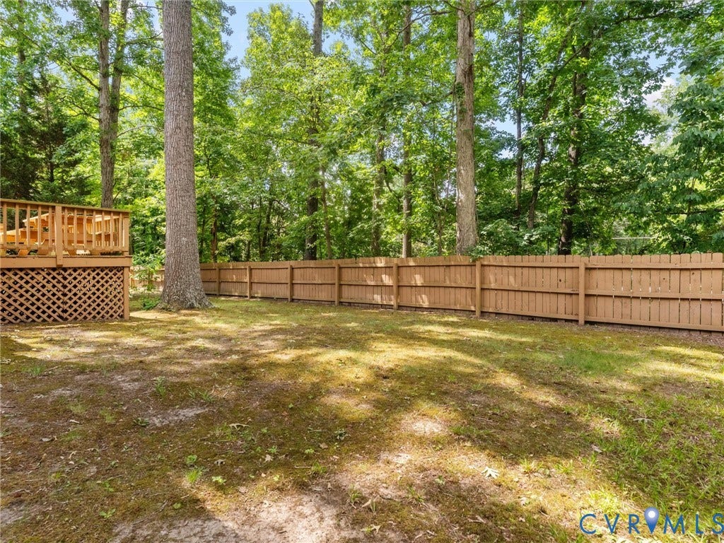 3700 Bremerton Drive, Wellesley, Henrico, VA 23233 Expansive backyard featuring a wood privacy fence, multi-level wood deck, and mature trees