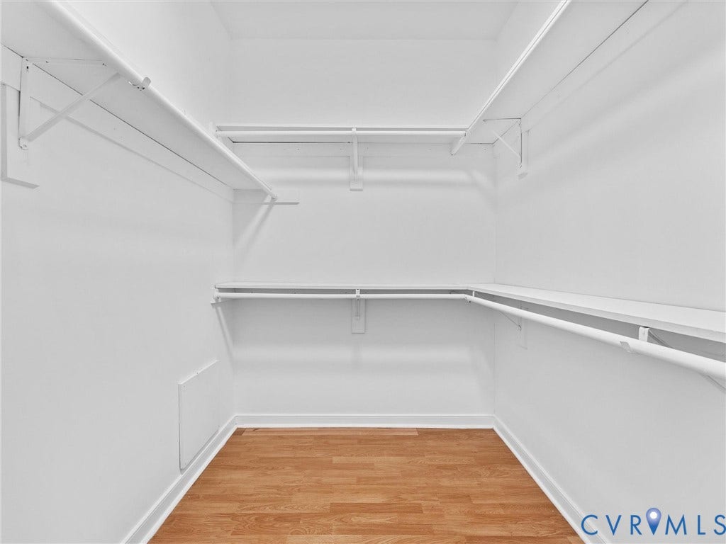 3700 Bremerton Drive, Wellesley, Henrico, VA 23233 Walk-in closet with wood-finish flooring, white shelving, and hanging rods