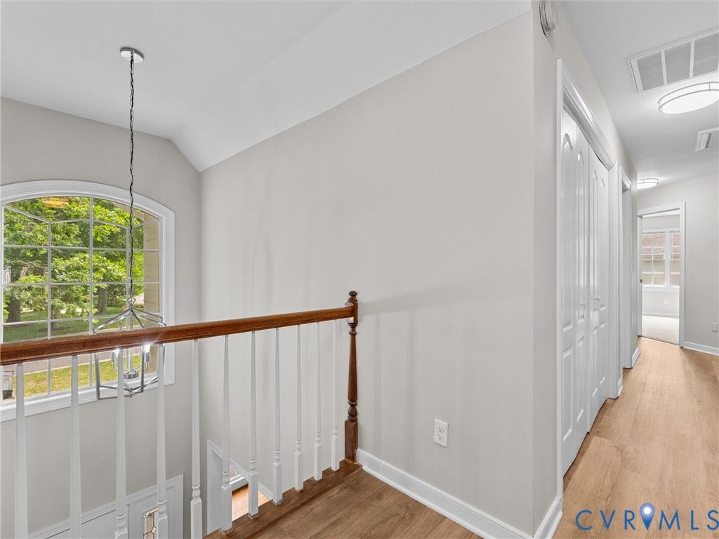 3700 Bremerton Drive, Wellesley, Henrico, VA 23233 Arch-top window with natural light, wood-finish flooring, white railing with wood-tone top rail, and recessed lighting
