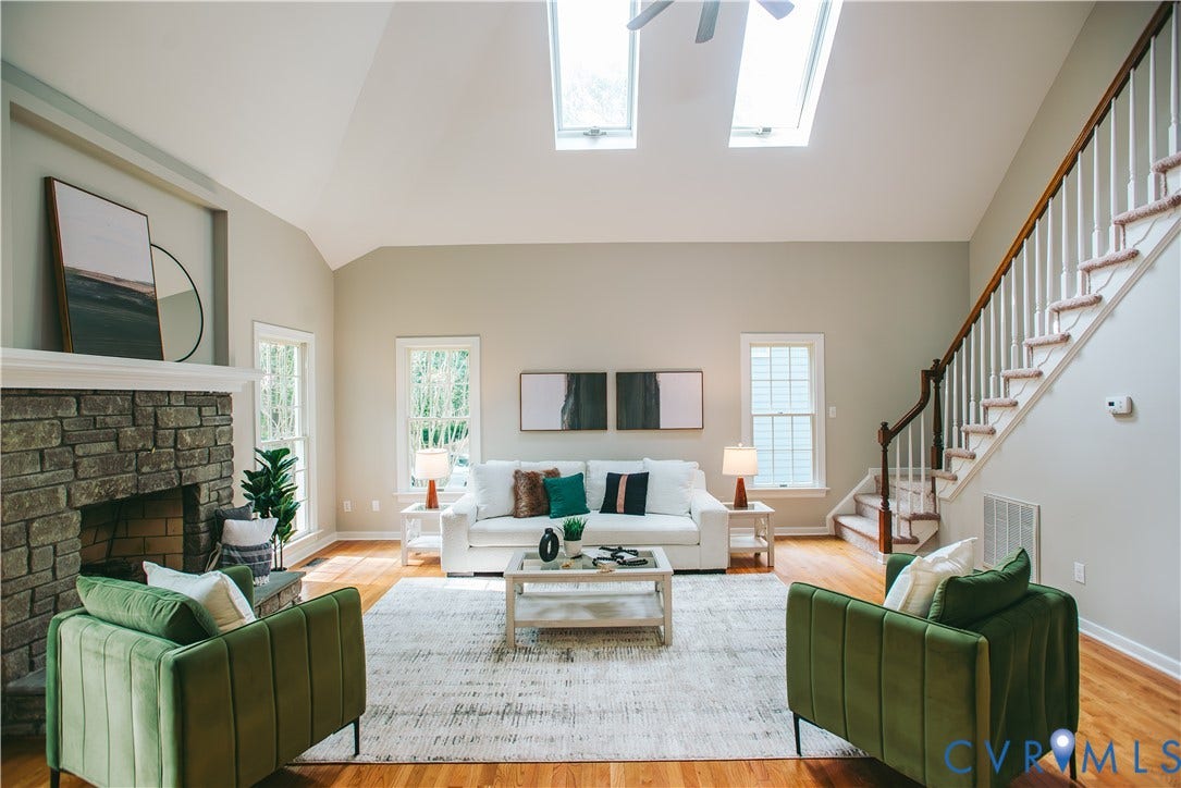 3700 Bremerton Drive, Wellesley, Henrico, VA 23233 Vaulted ceiling, skylights, wood-finish flooring, stone-clad fireplace, and a wood staircase with white balusters